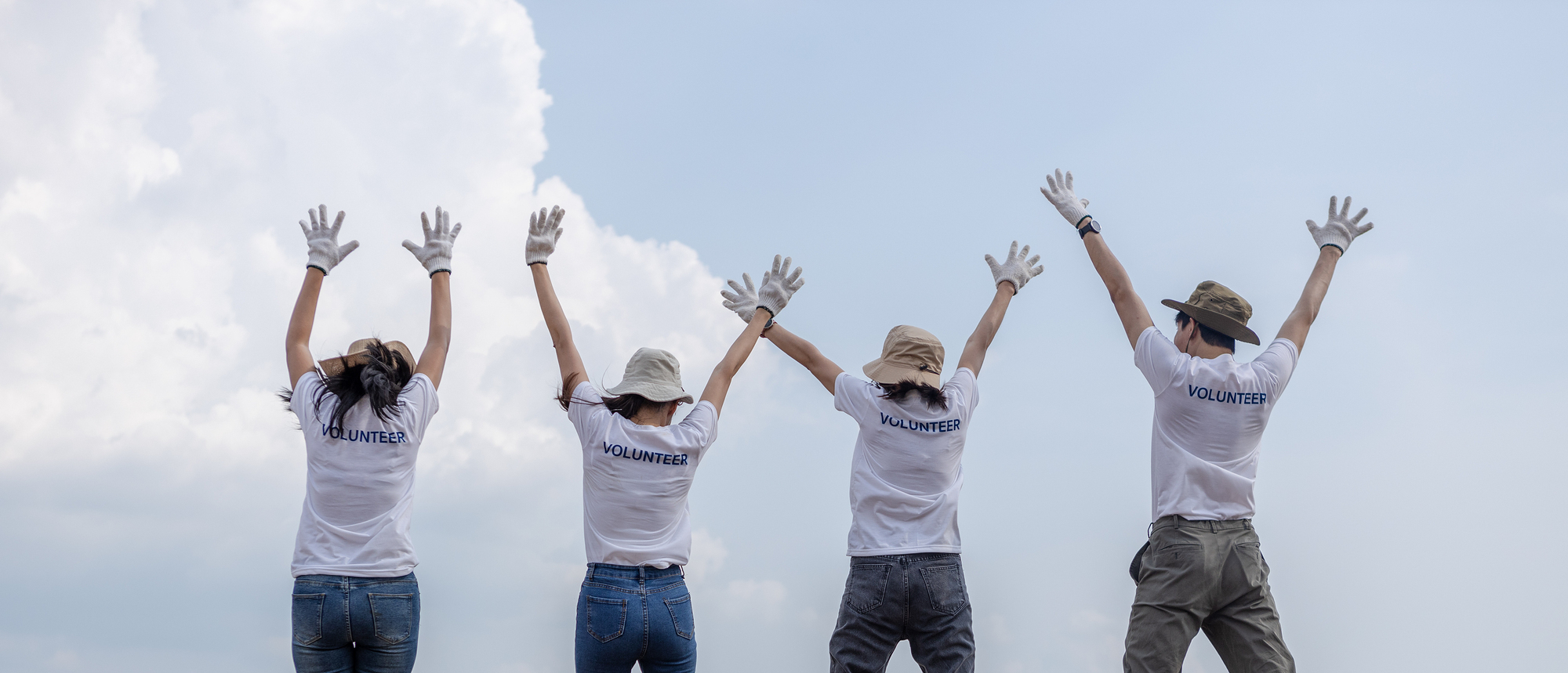 Group of volunteers cheerful success jumping together and arms raised. clean up garbage in tourist attractions. Conservation and care cleanliness in nature.