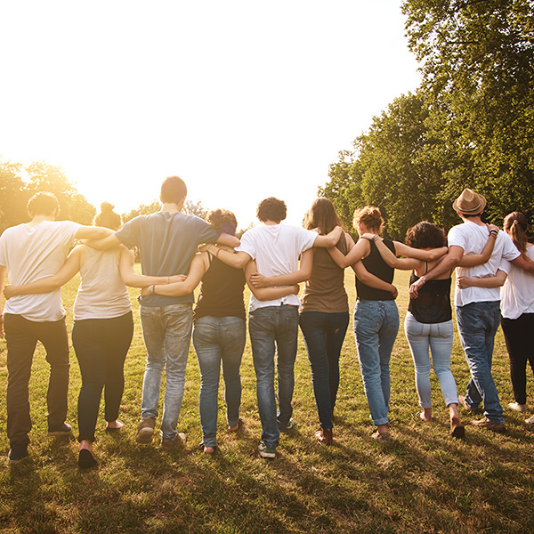 large group of friends enjoying a summer day at the park, back to school