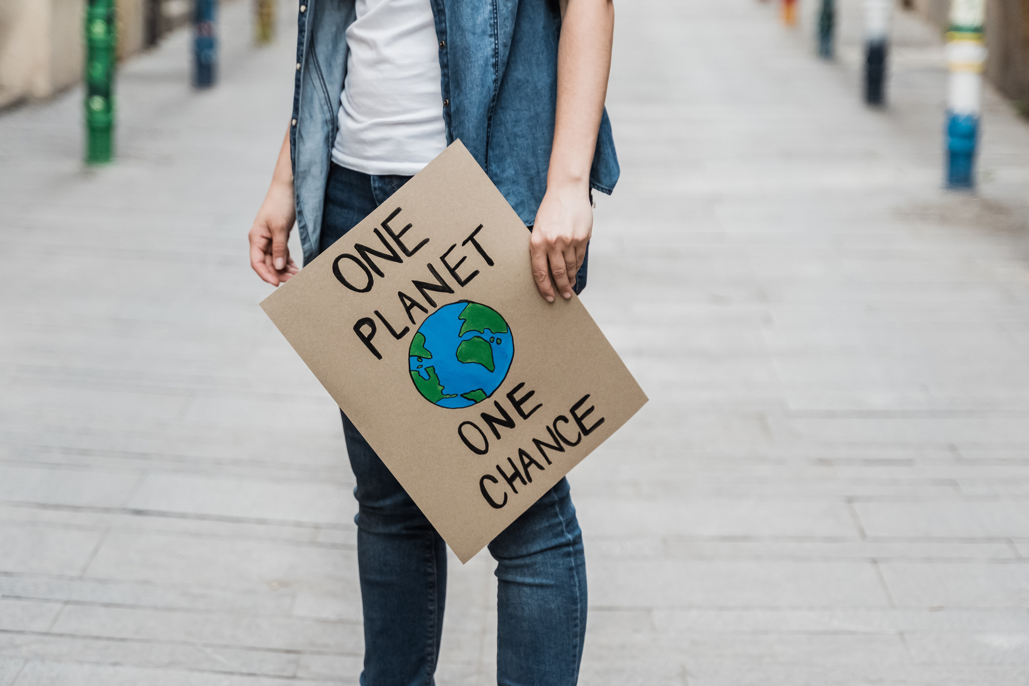 Demonstration on the city protesting against climate change and pollution - Global warming and environment concept - Focus on banner