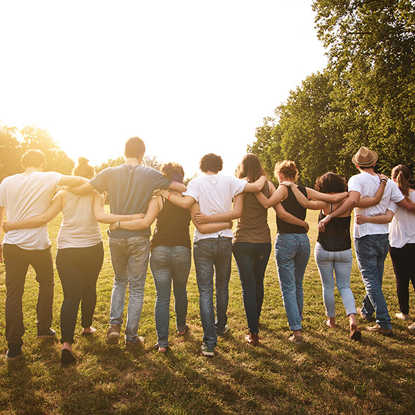 large group of friends enjoying a summer day at the park, back to school