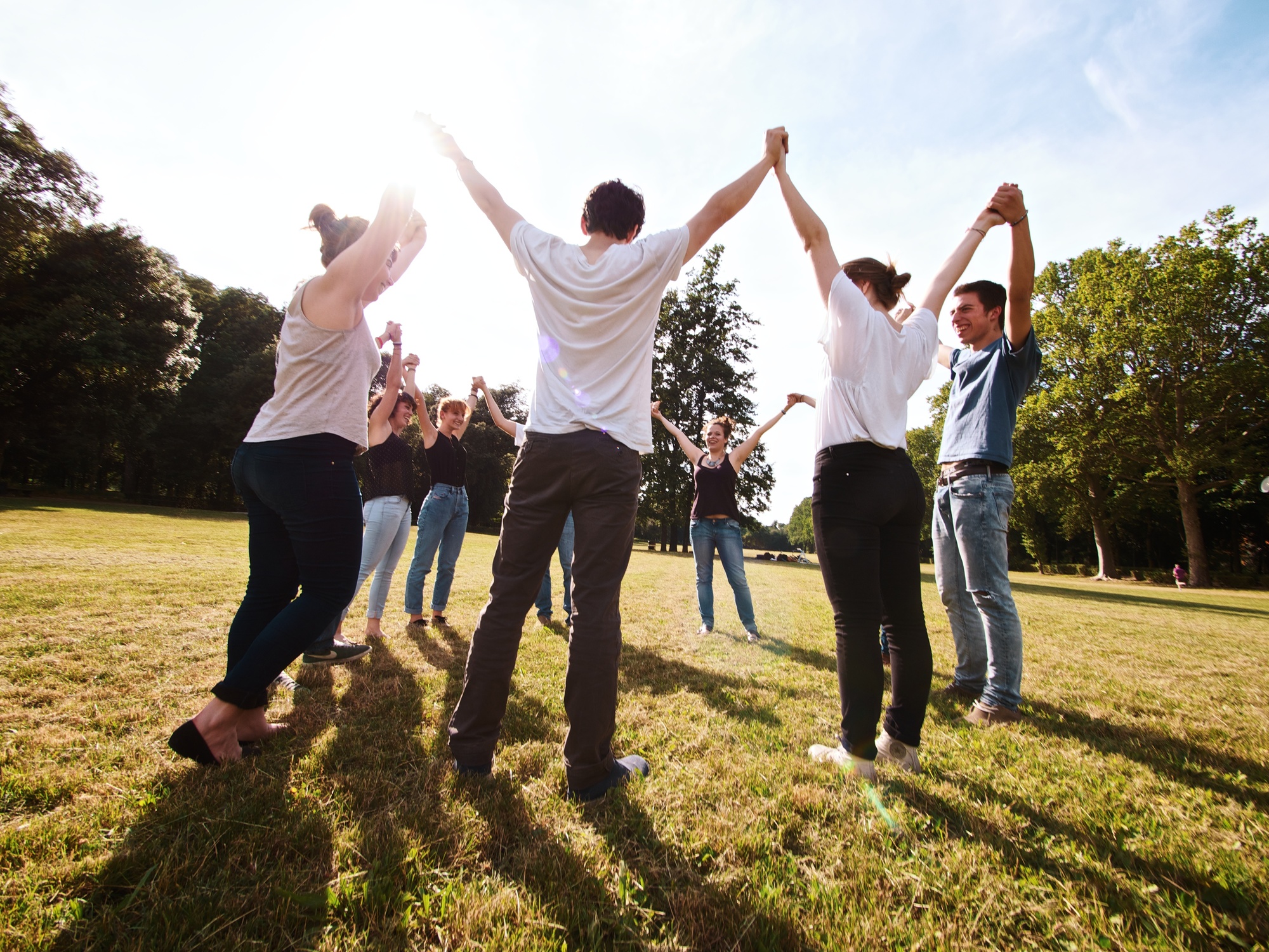 large group of friends enjoying a summer day at the park, back to school