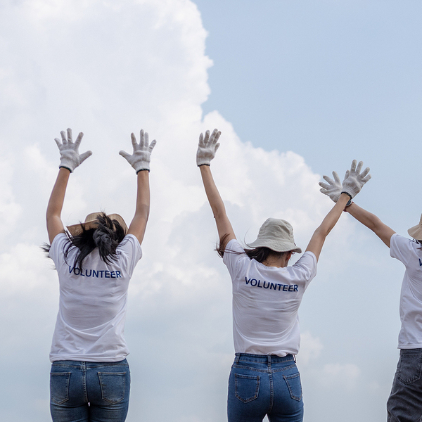 Group of volunteers cheerful success jumping together and arms raised. clean up garbage in tourist attractions. Conservation and care cleanliness in nature.